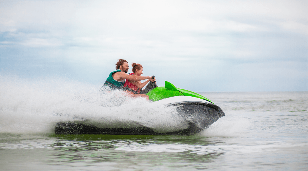 Parent and child riding a jet ski on the Gulf Coast